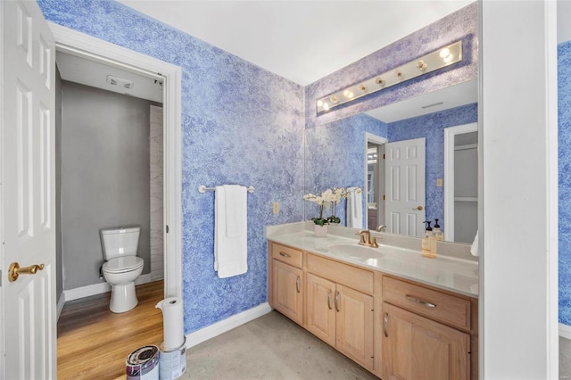 bathroom with wood-type flooring, toilet, and vanity