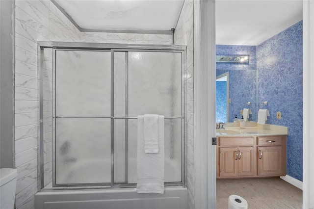 full bathroom featuring bath / shower combo with glass door, toilet, and vanity