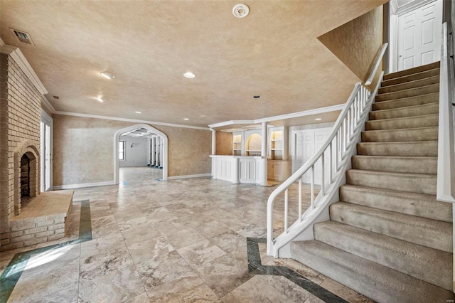 interior space featuring crown molding and a fireplace