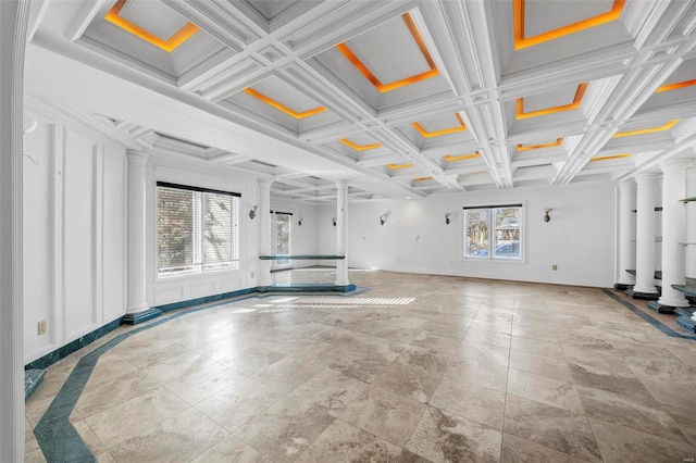 interior space with decorative columns, coffered ceiling, ornamental molding, and plenty of natural light