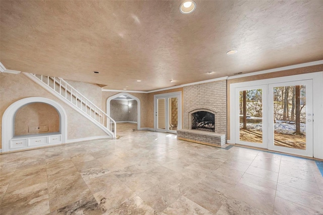 unfurnished living room with a brick fireplace and crown molding