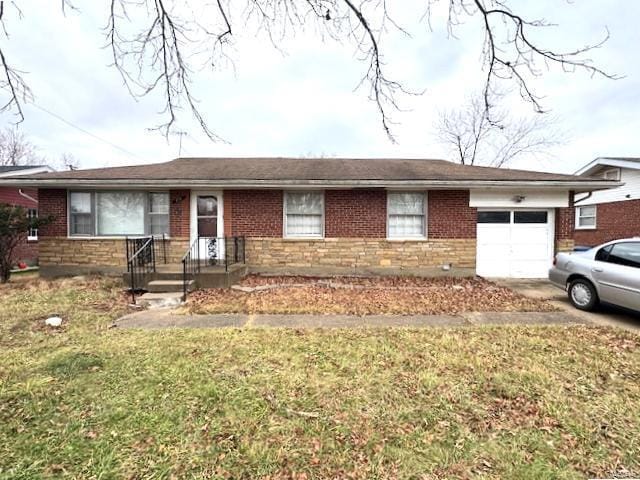 single story home featuring a garage and a front lawn