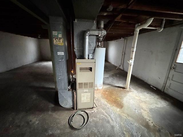 utility room featuring gas water heater and heating unit