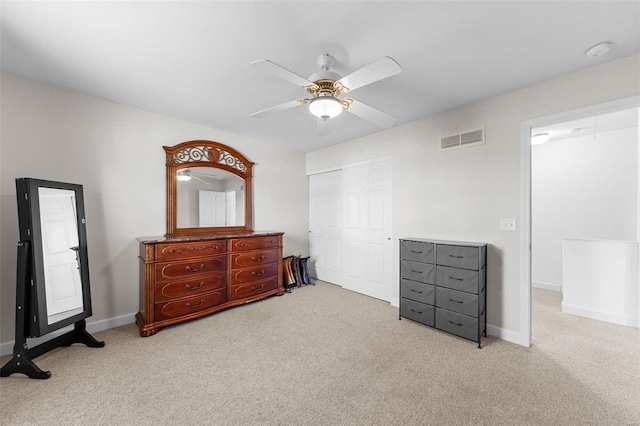 carpeted bedroom featuring a closet and ceiling fan