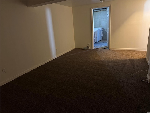 carpeted empty room with separate washer and dryer