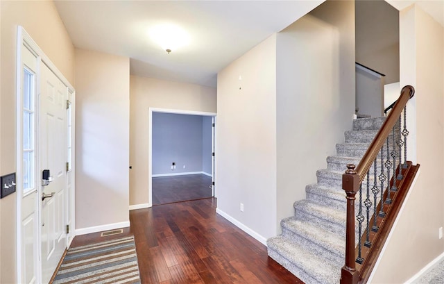 entryway with dark hardwood / wood-style flooring