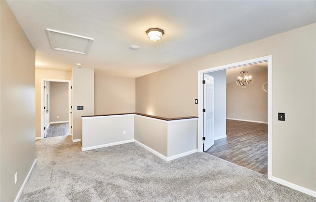 unfurnished room with carpet and an inviting chandelier