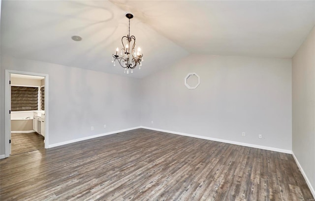 unfurnished room with dark hardwood / wood-style flooring, lofted ceiling, and a chandelier