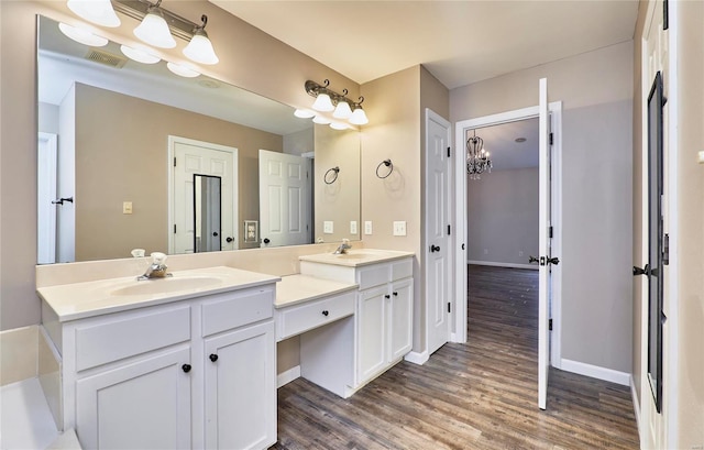 bathroom with vanity and hardwood / wood-style flooring