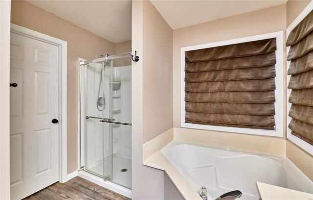 bathroom with hardwood / wood-style floors and plus walk in shower