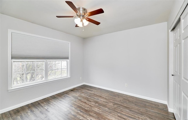 unfurnished bedroom featuring dark hardwood / wood-style flooring, a closet, and ceiling fan