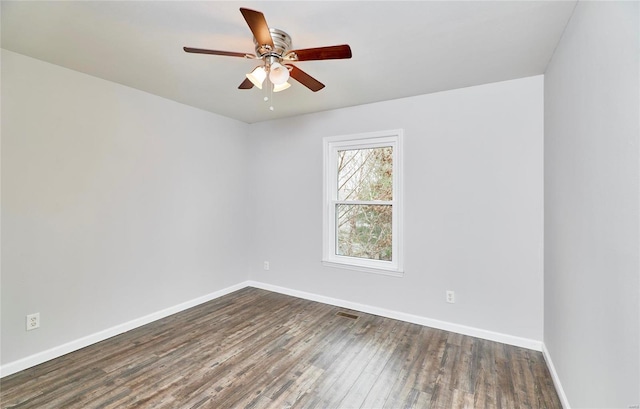 spare room featuring ceiling fan and dark wood-type flooring