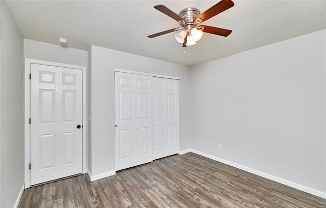 unfurnished bedroom featuring ceiling fan, a closet, and dark hardwood / wood-style floors