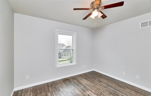 empty room with ceiling fan and dark hardwood / wood-style floors