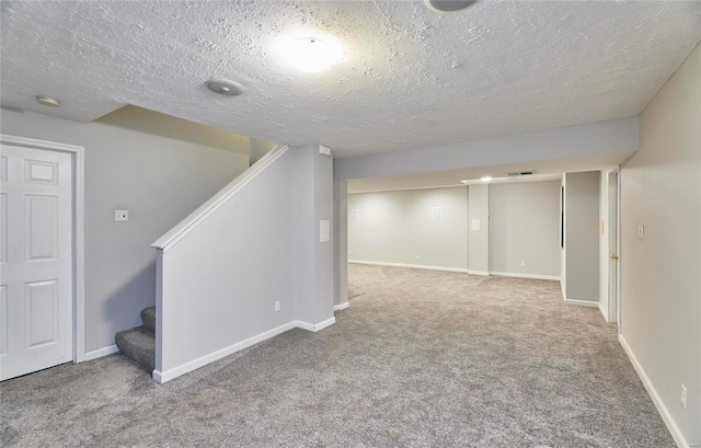 basement with carpet and a textured ceiling