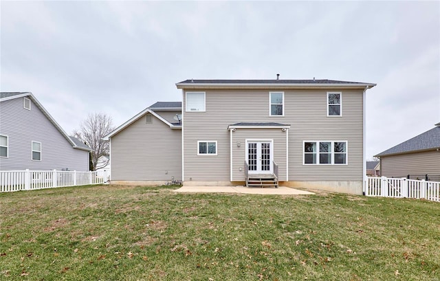 back of house with a lawn, a patio area, and french doors