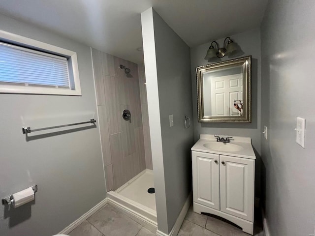 bathroom with tile patterned floors, vanity, and a tile shower