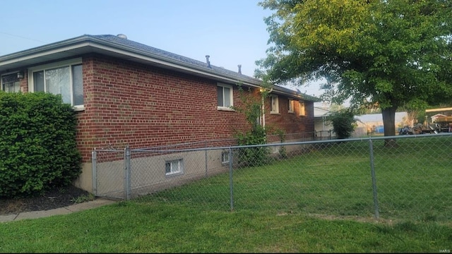 view of side of home with a lawn