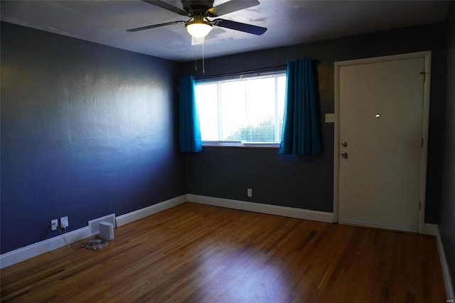 spare room with ceiling fan and hardwood / wood-style flooring