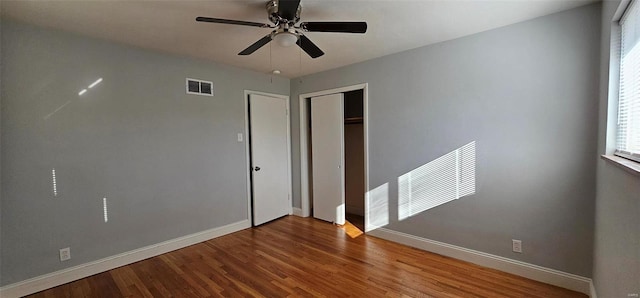 empty room with ceiling fan and hardwood / wood-style flooring