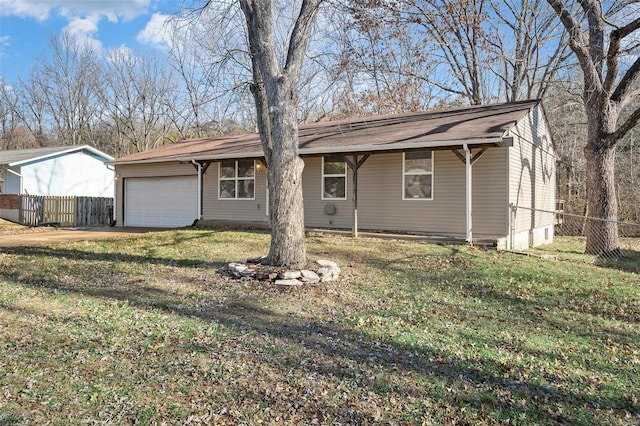 back of property with a yard and a garage