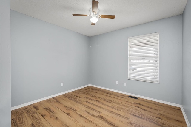 empty room with wood-type flooring and ceiling fan