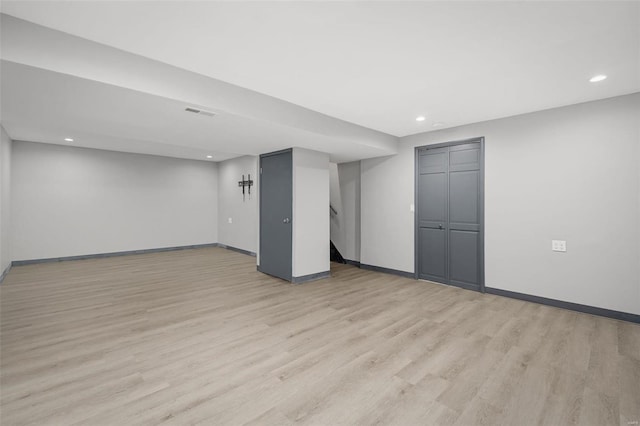 basement with light hardwood / wood-style floors