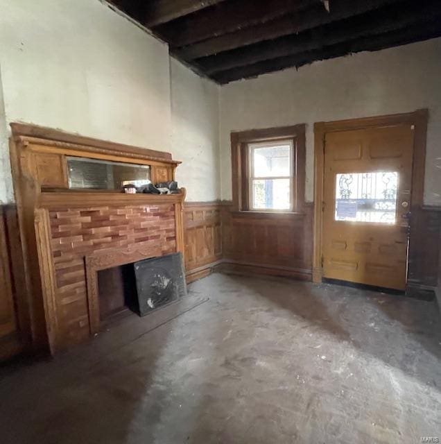 unfurnished living room with concrete floors