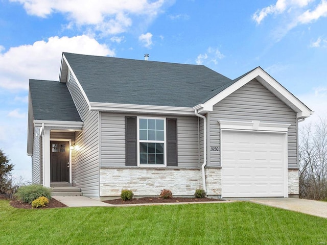 view of front of property with a front yard and a garage