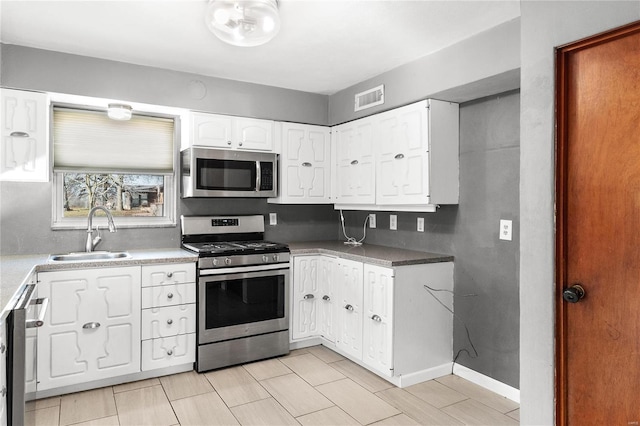 kitchen with sink, white cabinets, and stainless steel appliances