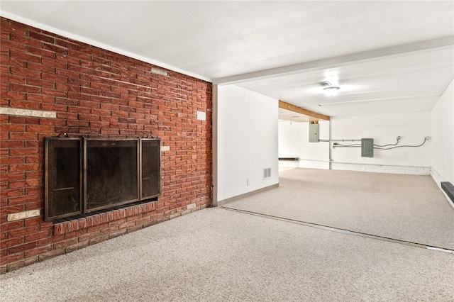 unfurnished living room featuring a brick fireplace and electric panel