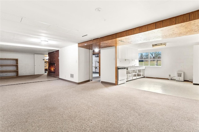 basement with carpet and a fireplace