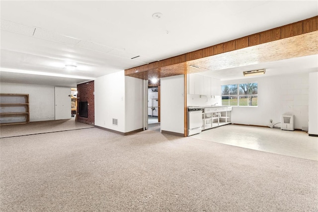 basement featuring carpet floors and a brick fireplace