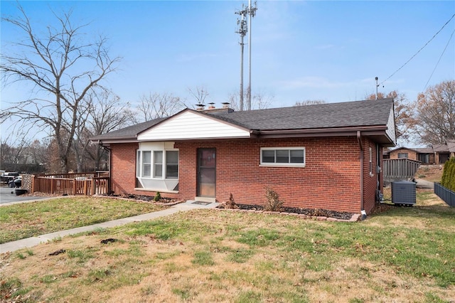 view of front of home featuring a front yard and central AC unit