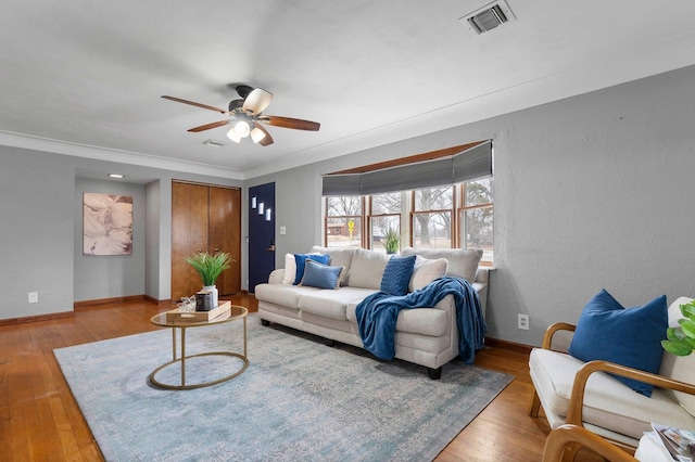 living room with ceiling fan and light hardwood / wood-style flooring