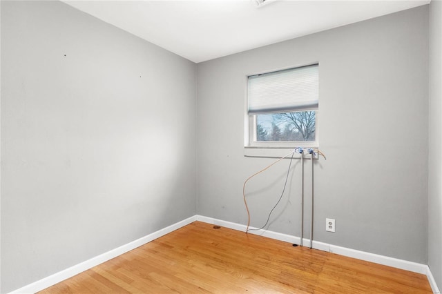 spare room featuring wood-type flooring