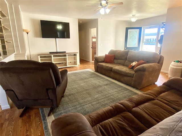 living room with ceiling fan and light hardwood / wood-style flooring