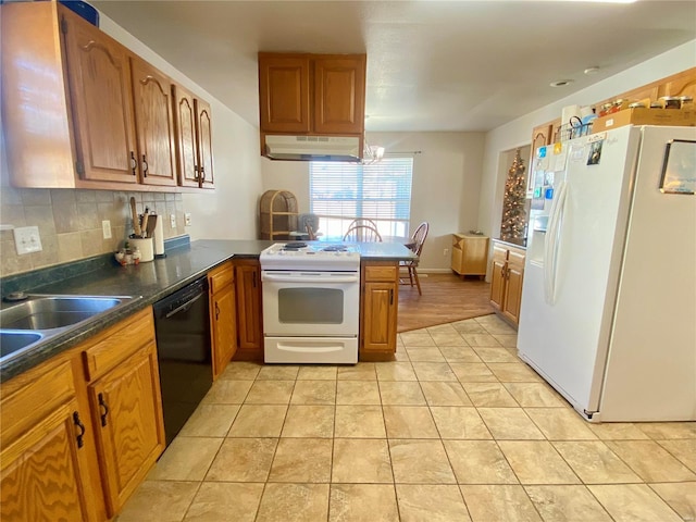 kitchen featuring tasteful backsplash, kitchen peninsula, light tile patterned floors, and white appliances