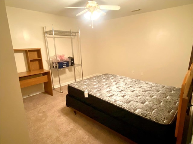 bedroom with ceiling fan and light carpet