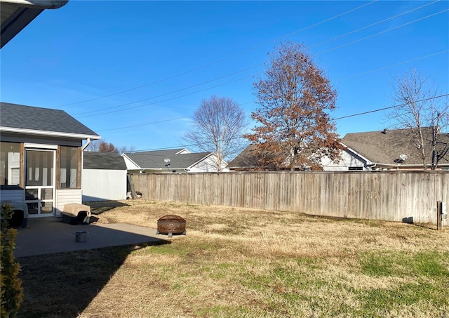 view of yard featuring a patio, a fire pit, and a sunroom