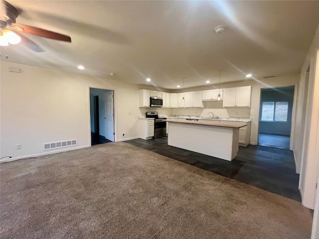 kitchen featuring sink, ceiling fan, a kitchen island, white cabinetry, and stainless steel appliances