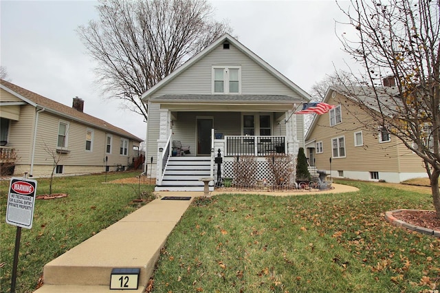 bungalow-style home with a front lawn and covered porch