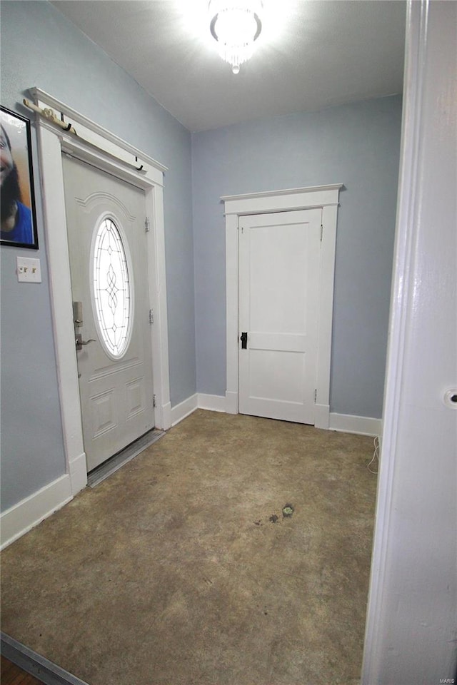 view of carpeted foyer entrance