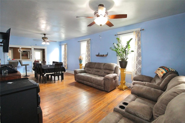 living room featuring light hardwood / wood-style floors and ceiling fan