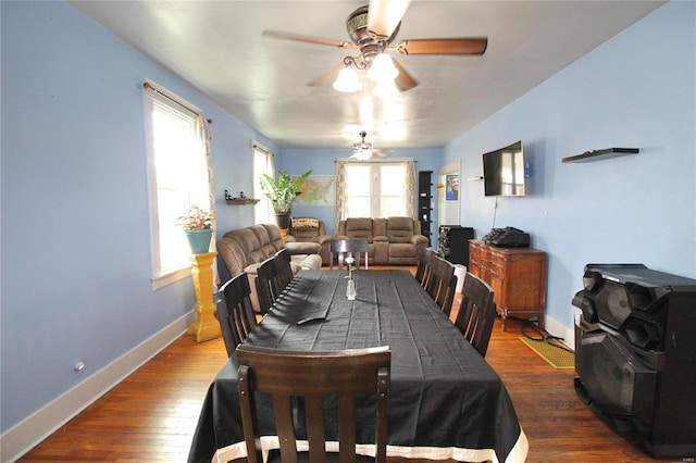 dining space featuring ceiling fan and dark wood-type flooring