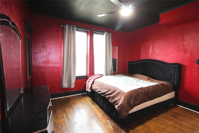 bedroom featuring ceiling fan and dark hardwood / wood-style flooring