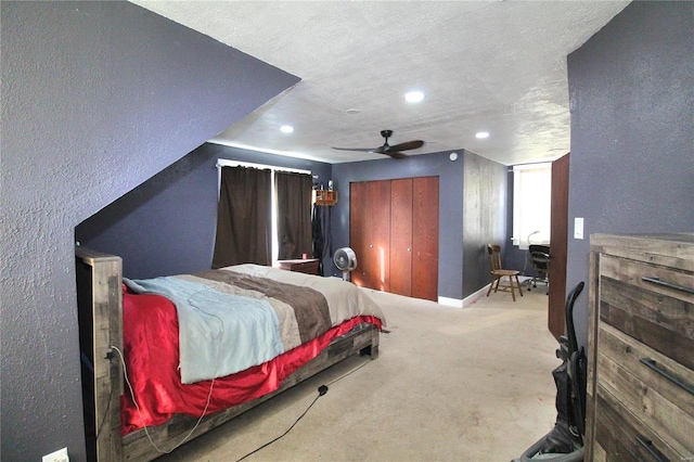 carpeted bedroom featuring a textured ceiling and ceiling fan