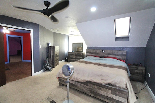 bedroom with ceiling fan, carpet floors, and vaulted ceiling