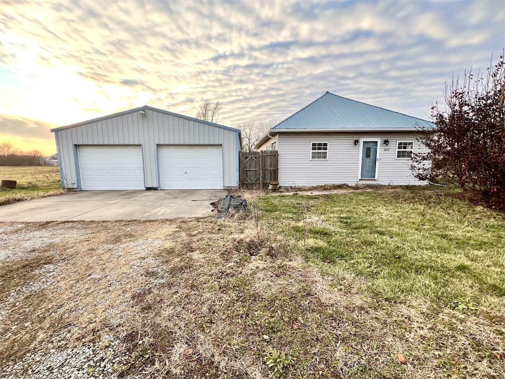 exterior space featuring a yard, an outbuilding, and a garage