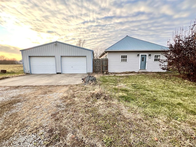 exterior space featuring a yard, an outbuilding, and a garage